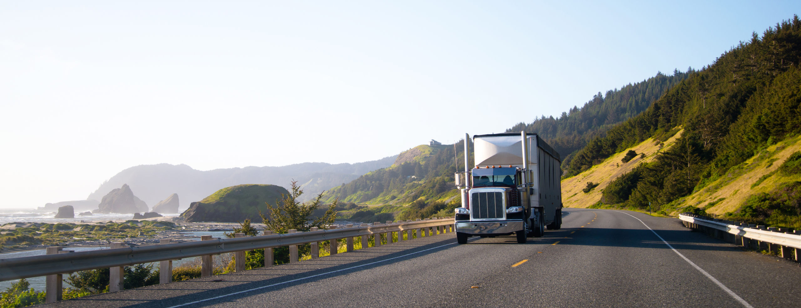 semi truck with trailer driving on highway along the Pacific coast in Northwest